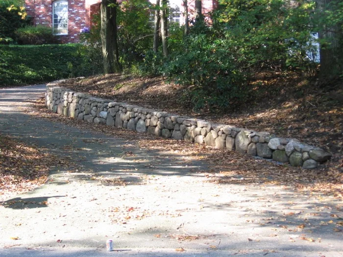 Finished natural stone retaining wall